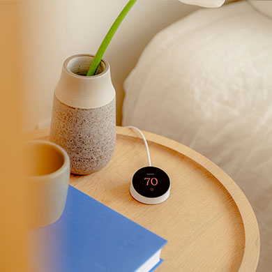 Quilt thermostat on nightstand in bedroom